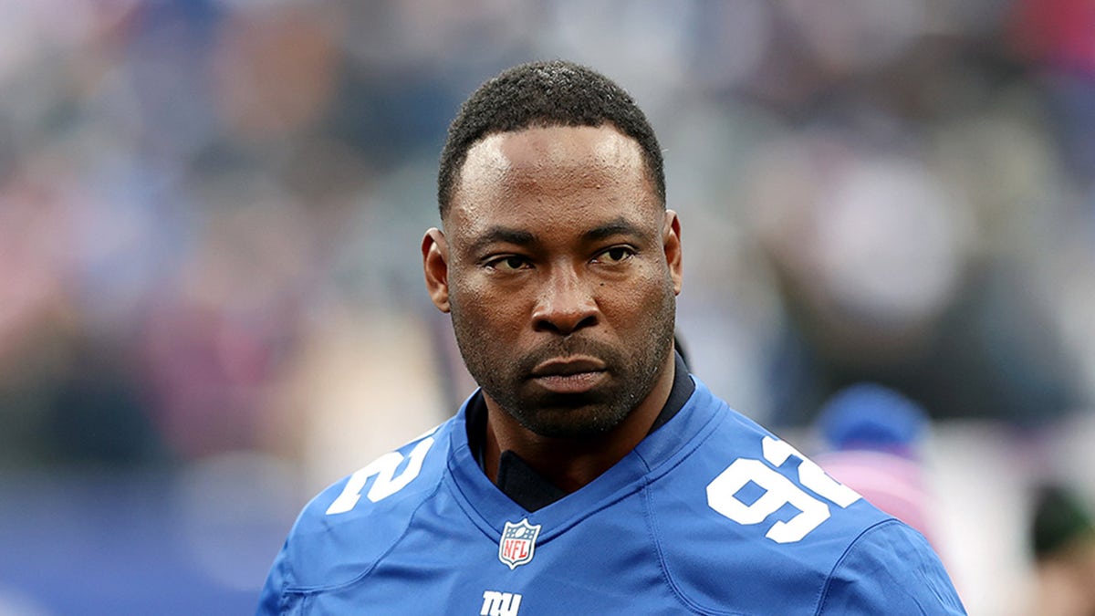 Justin Tuck looks on field