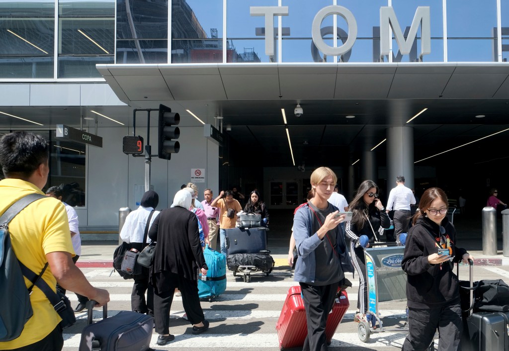 Travelers maneuver in and out of the Tom Bradley International Terminal at LAX on Aug. 30, 2023, in Los Angeles. 