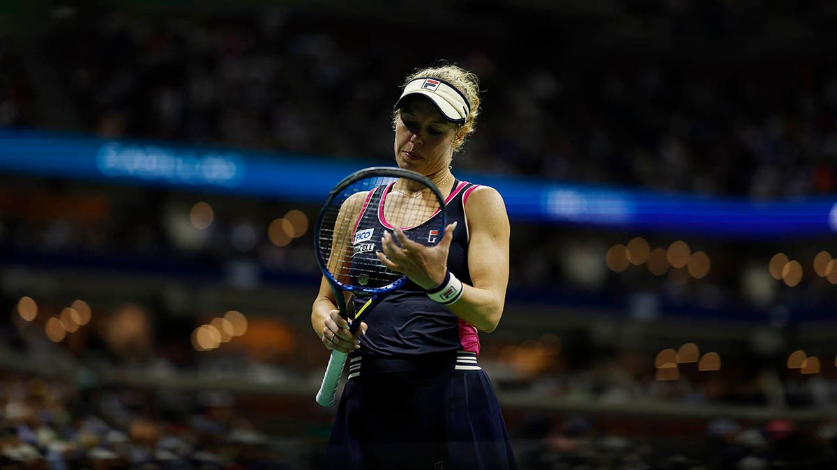 Laura Siegemund looks at her racket