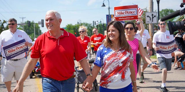 Former Vice President and 2024 Presidential Candidate Mike Pence walks alongside Karen Pence in the Urbandale 4th of July Celebration