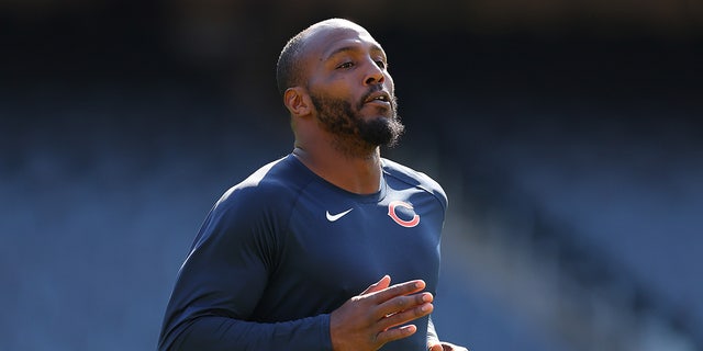 Robert Quinn warms up before a game