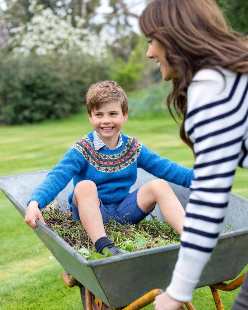 Kate Middleton with her son Prince Louis, pushing him in a wheelbarrow. 