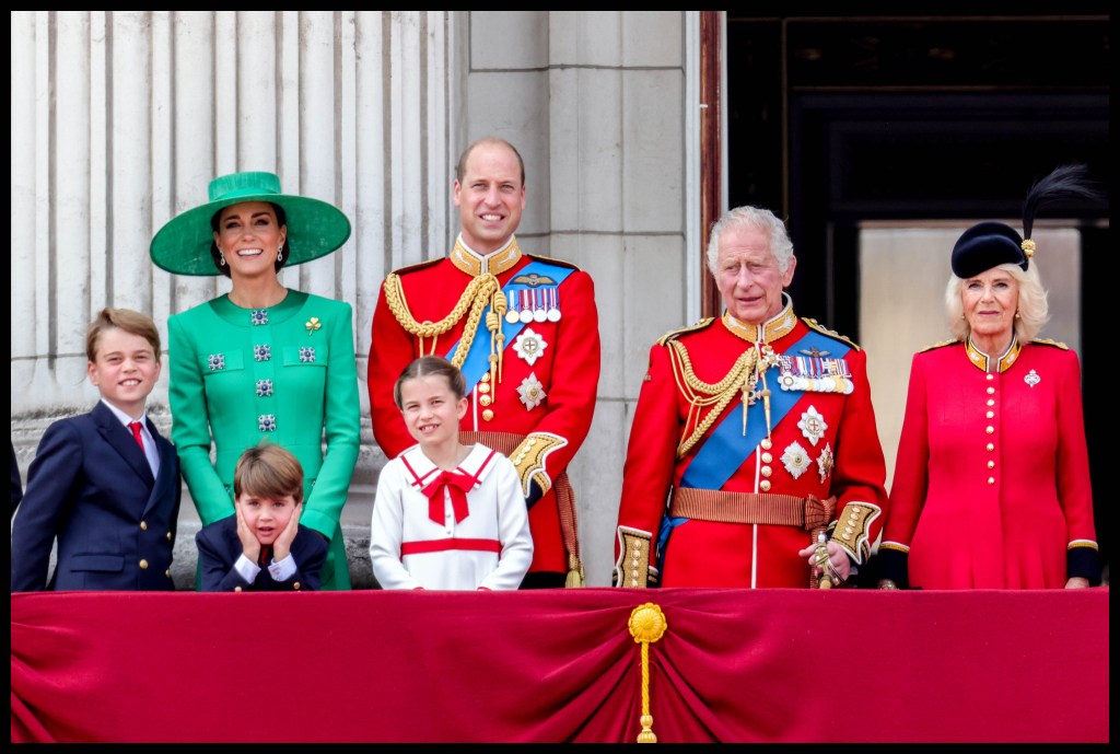 The royal family standing on the balcony of Buckingham Palace. 