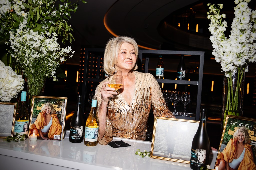 Photo of Martha Stewart in a sequined gown behind a bar. 