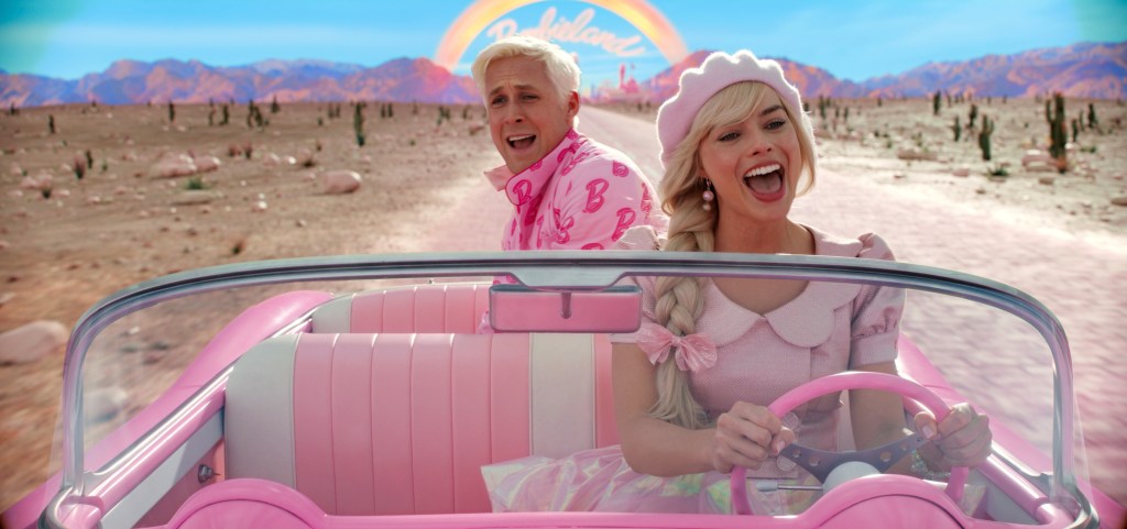Still of Barbie and Ken driving car from "Barbie."