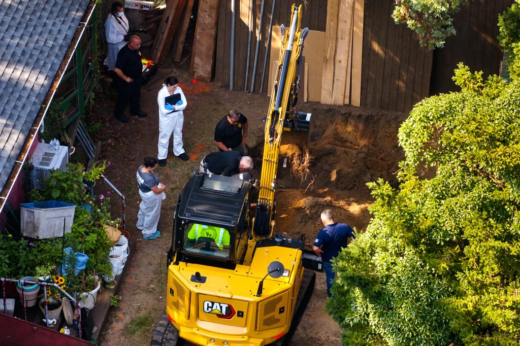 Crime scene investigators dig for evidence with a backhoe in the backyard of Heuermann's Long Island home.