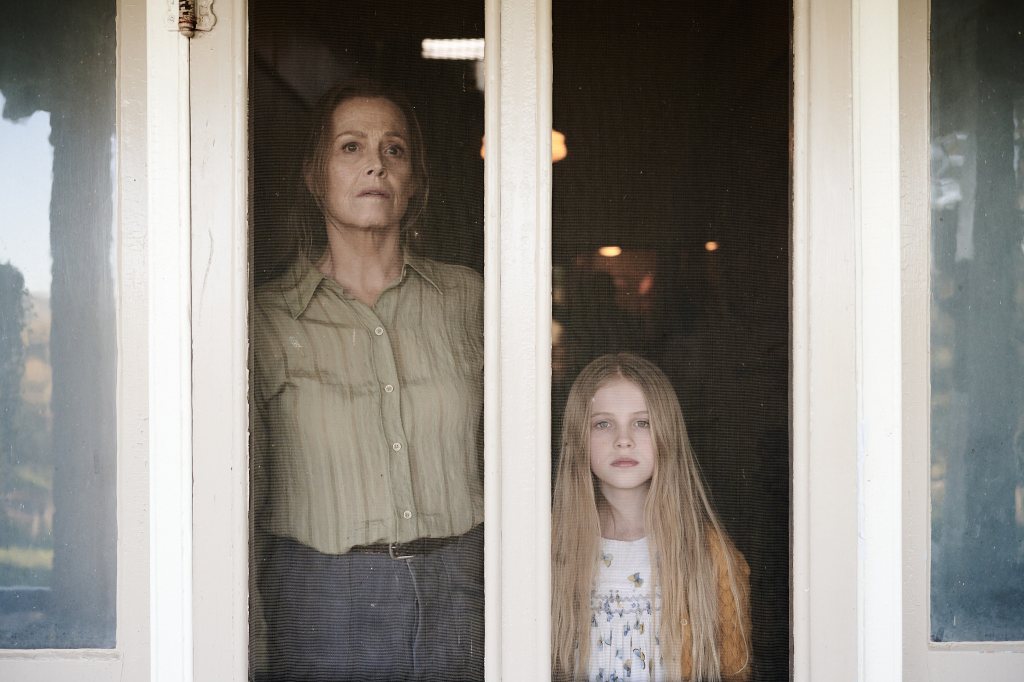Sigourney Weaver as June and Alyla Browne as the younger Alice standing next to each other. 