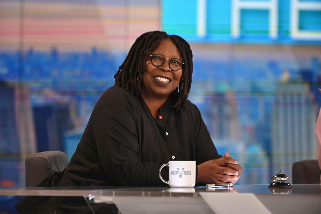 Photo of Whoopi Golberg smiling on the set of "The View." 