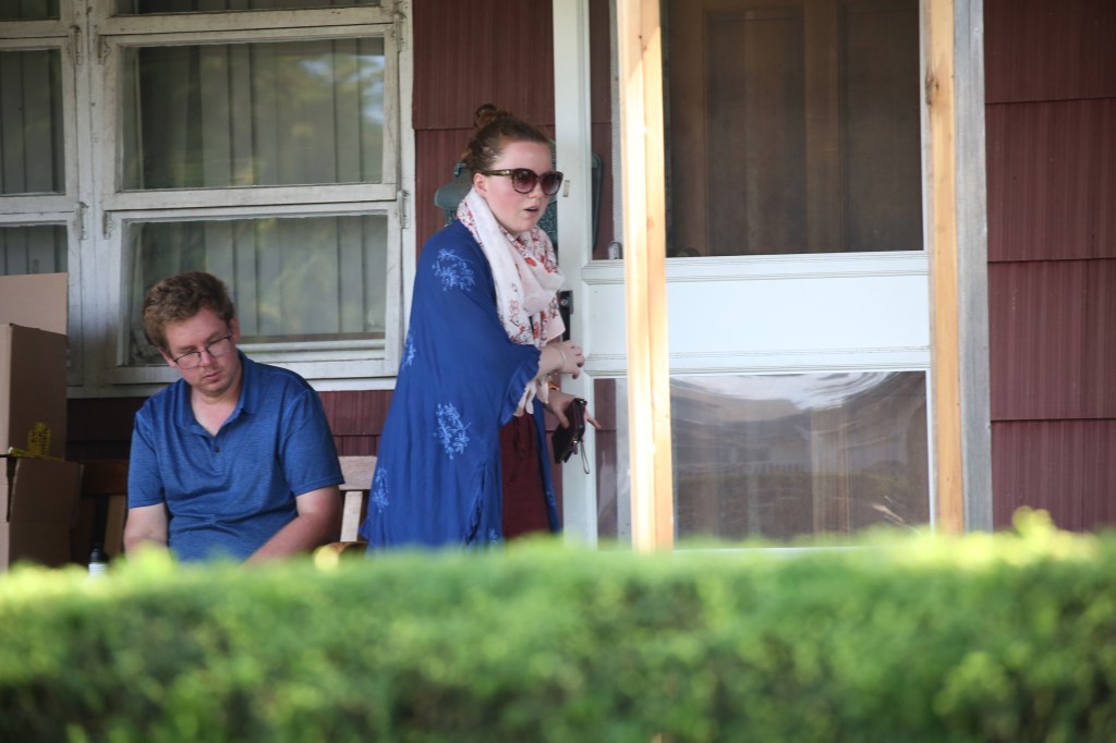 Victoria Heuermann, 27, and her brother keep a low profile on the family's front porch.