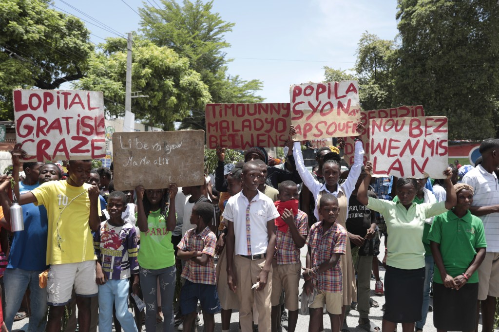 Protestors on Monday with signs.