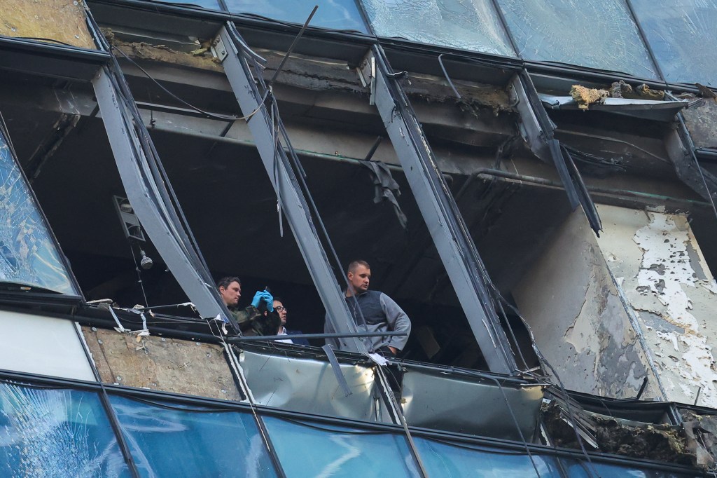 Members of security services investigated the damaged office building.