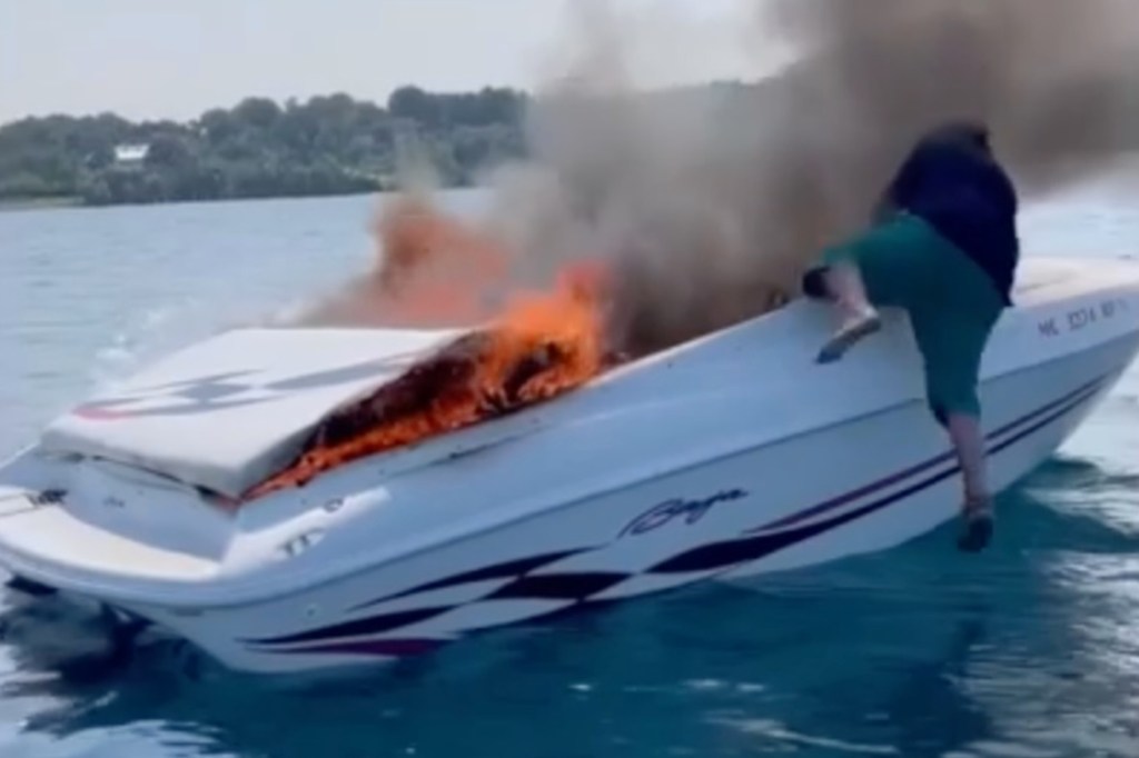 Man jumps off burning boat