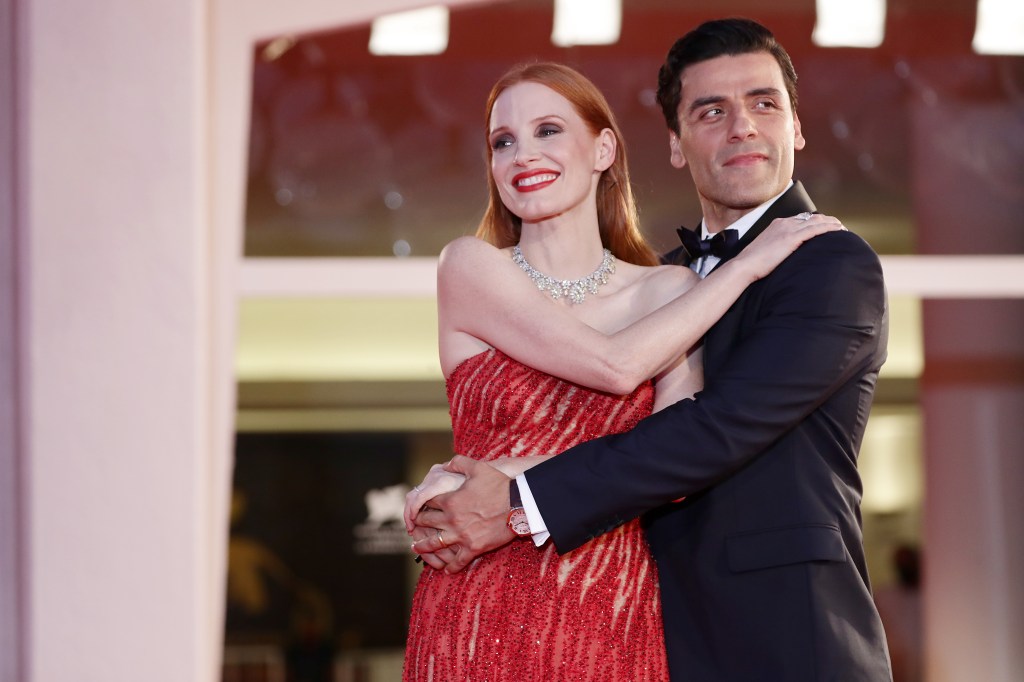 Chastain and Isaac hug at Venice Film Festival promoting their miniseries.