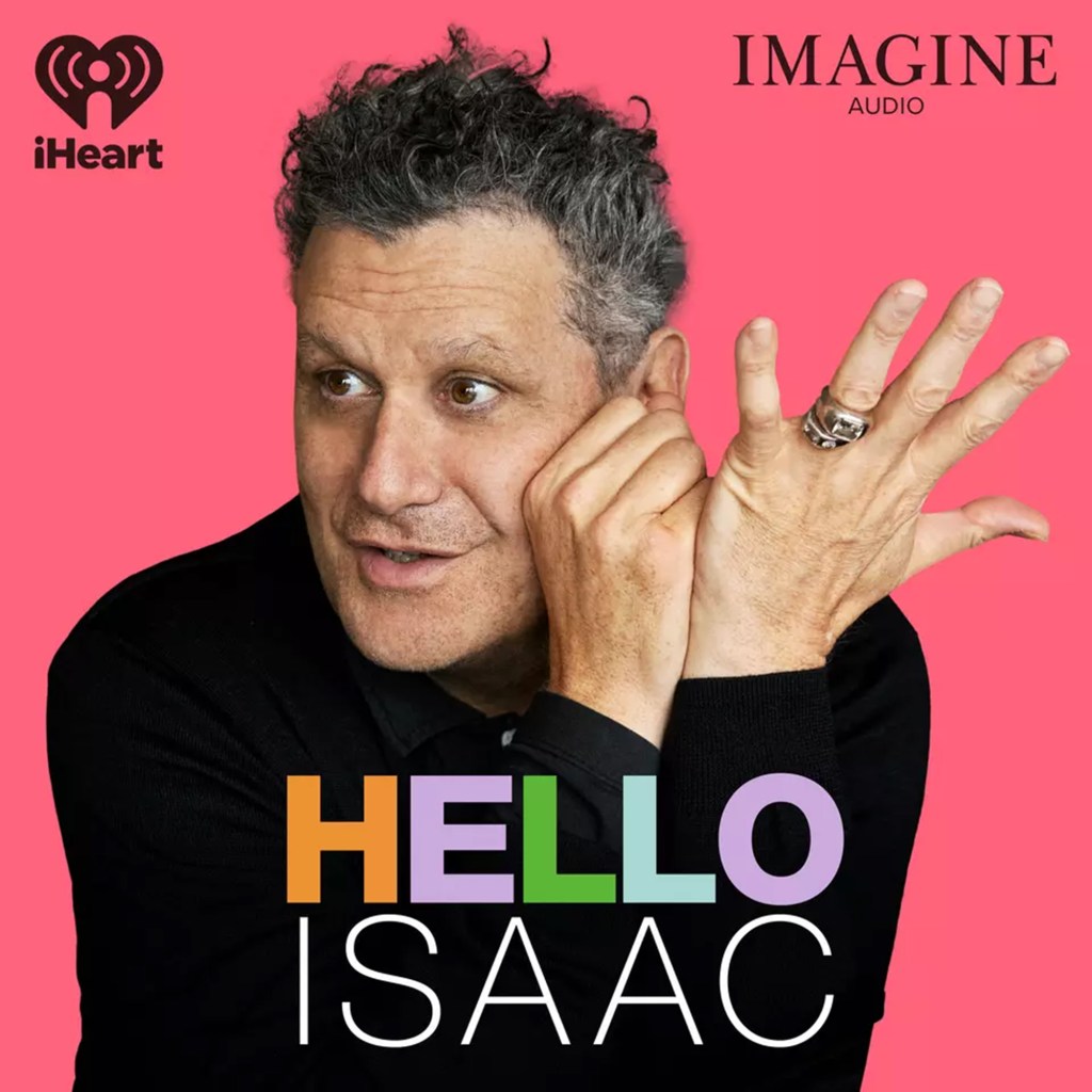 Photo of Isaac Mizrahi against a bright pink background. 