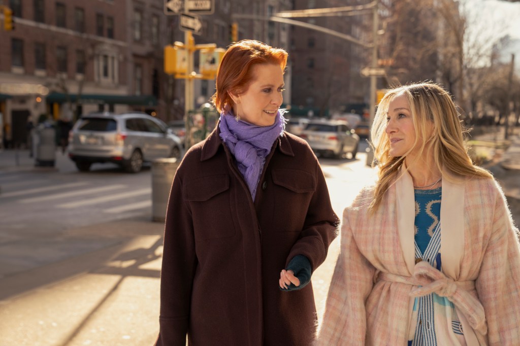 Miranda and Carrie walk down the street.