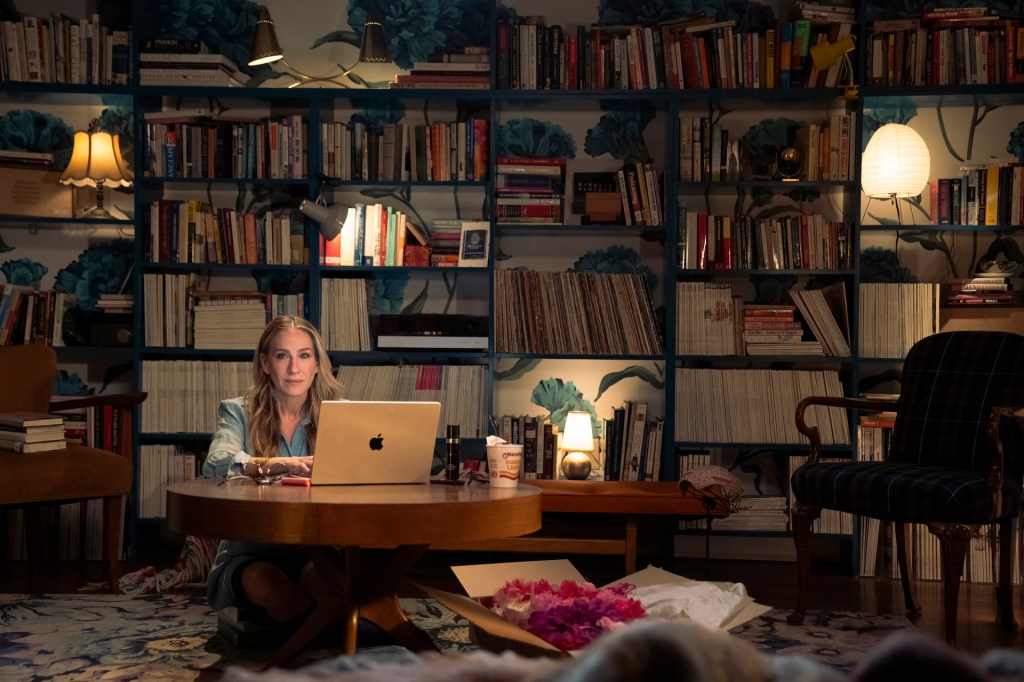 Carrie types at her desk at home.