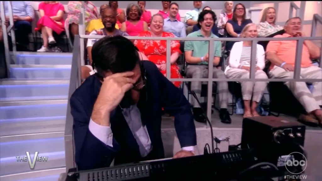 "The View" producer Brian Teta burying his head in his hands. 