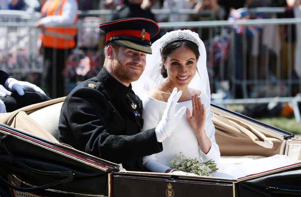 Photo of Meghan Markle and Prince Harry waving to the crowd at their wedding. 