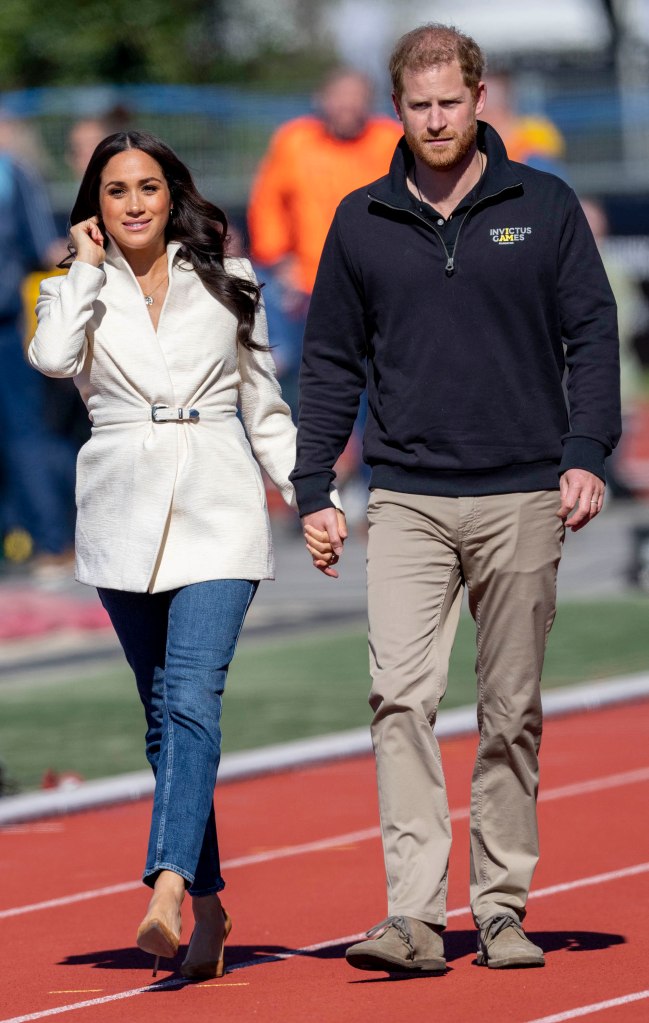 Photo of Meghan Markle and Prince Harry holding hands. 