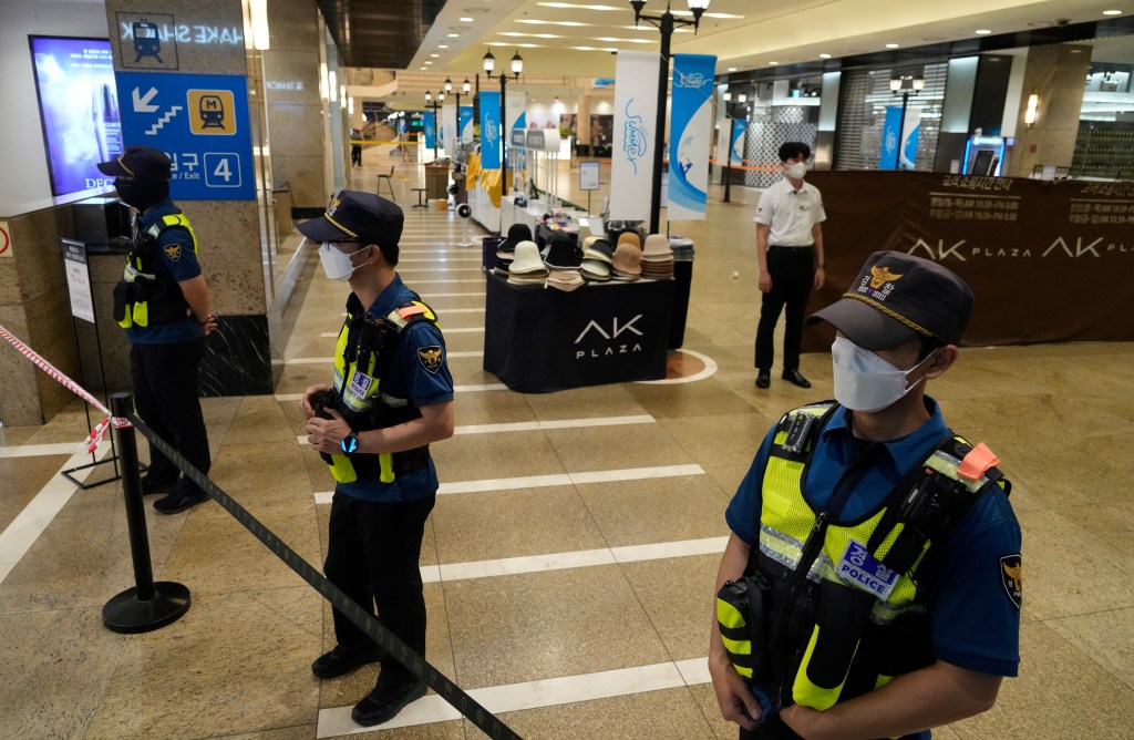 Police officers cordon off the scene near a subway station in Seongnam, South Korea.