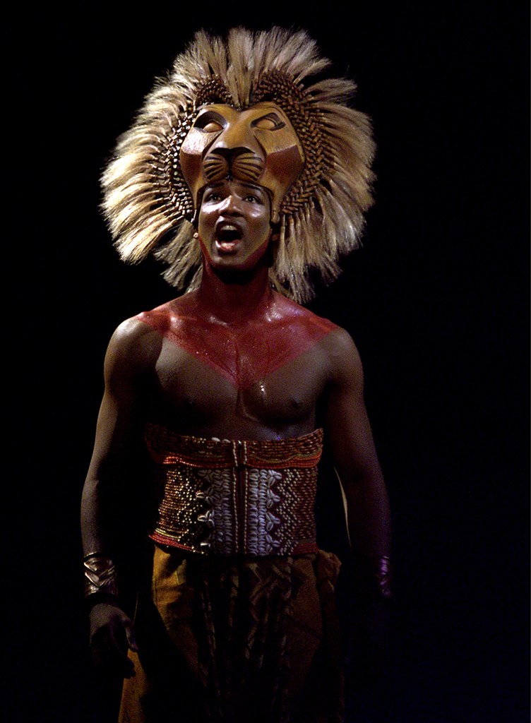  Simba (Clifton Oliver) singing on stage in "The Lion King."