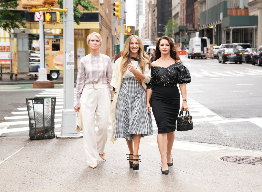 Miranda (Cynthia Nixon), Carrie (Sarah Jessica Parker) and Charlotte (Kristin Davis) on a sidewalk. 