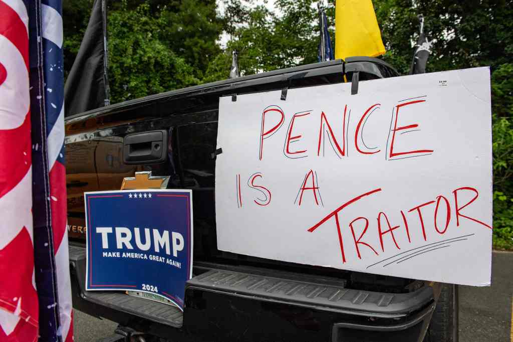 Supporters of former US president Donald Trump demonstrate outside a town hall where Presidential hopeful and former Vice President Mike Pence holds a campaign event.