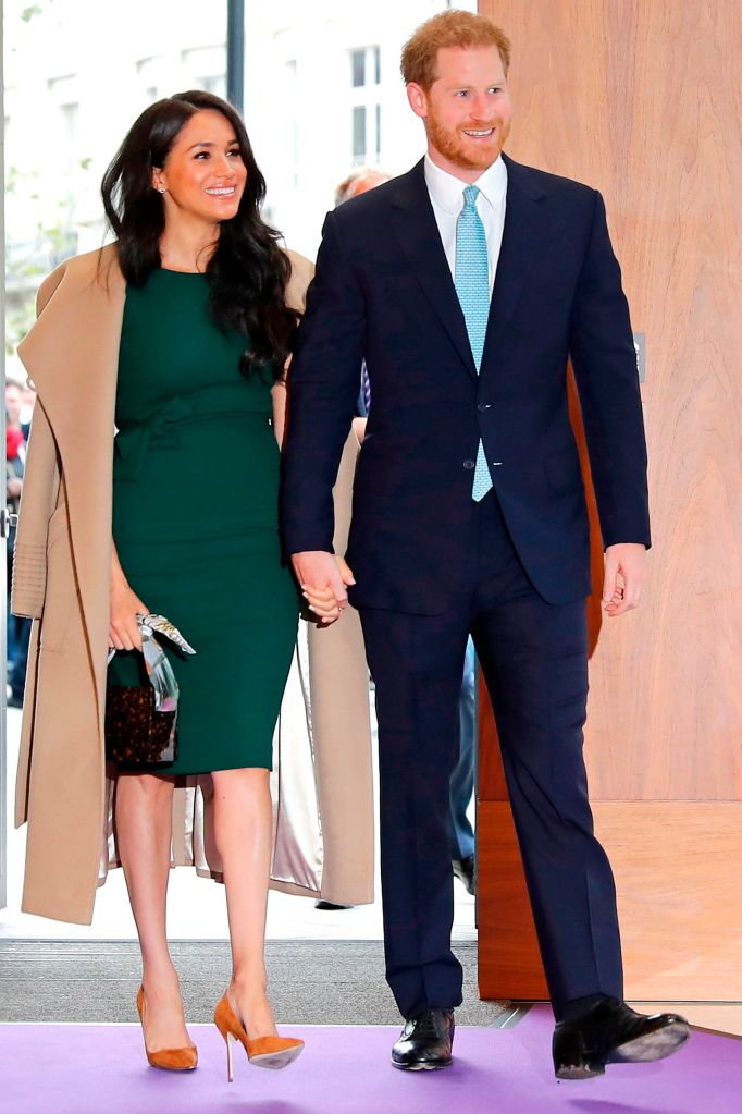 Photo of Meghan and Harry holding hands. 