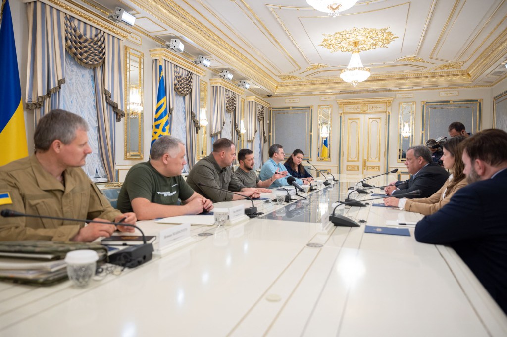 Chris Christie is pictured seated across from Ukraine leader Volodymyr Zelensky