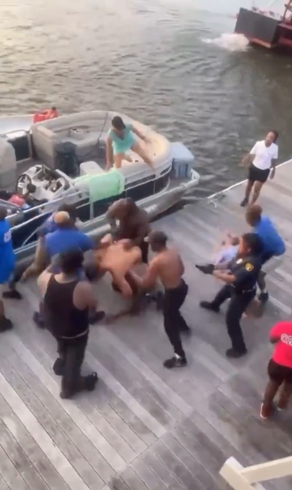 People fight on a dock
