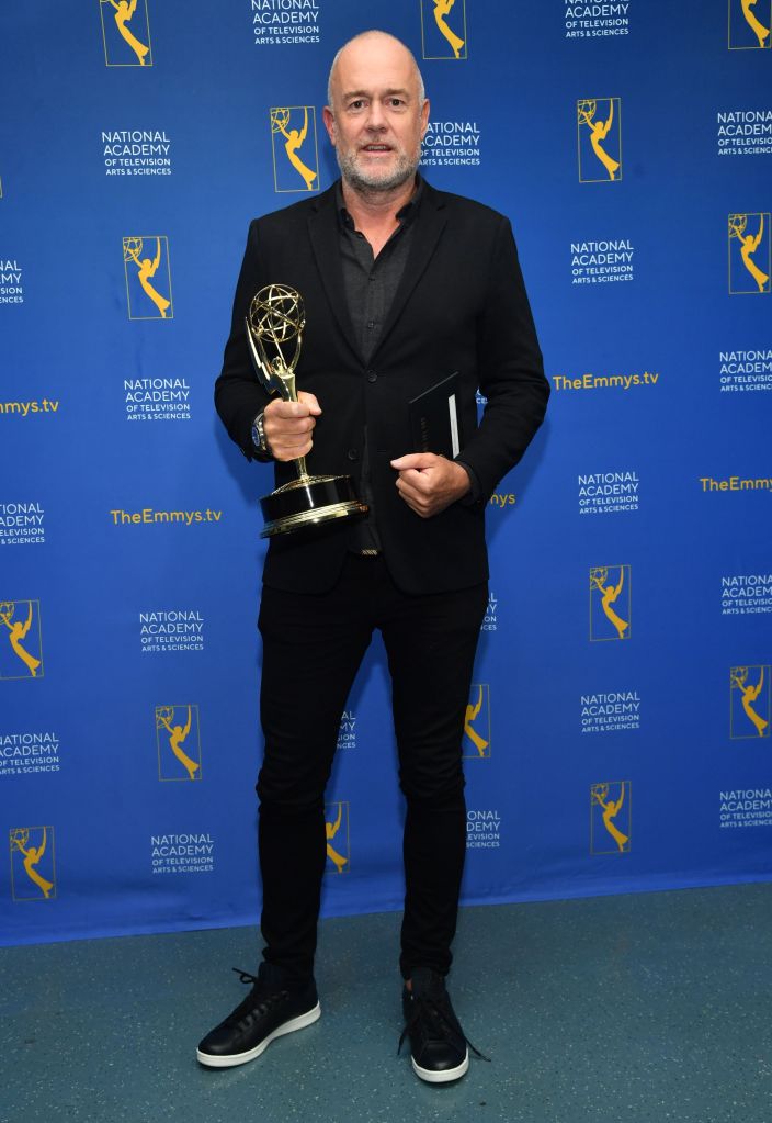 Michael Davies stands with his Emmy.