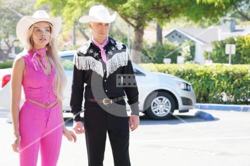 Photo of Margot Robbie and Ryan Goslin in western-themed outfits. 