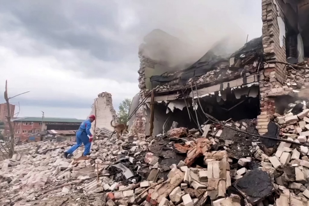 This grab from a handout footage taken and released by the Russian Emergencies Ministry on August 9, 2023 shows emergency services working at the site of the explosion