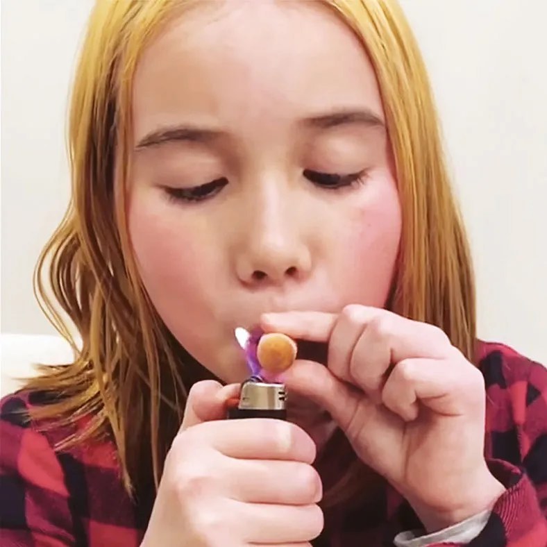 Lil Tay appearing to "smoke" a baby carrot
