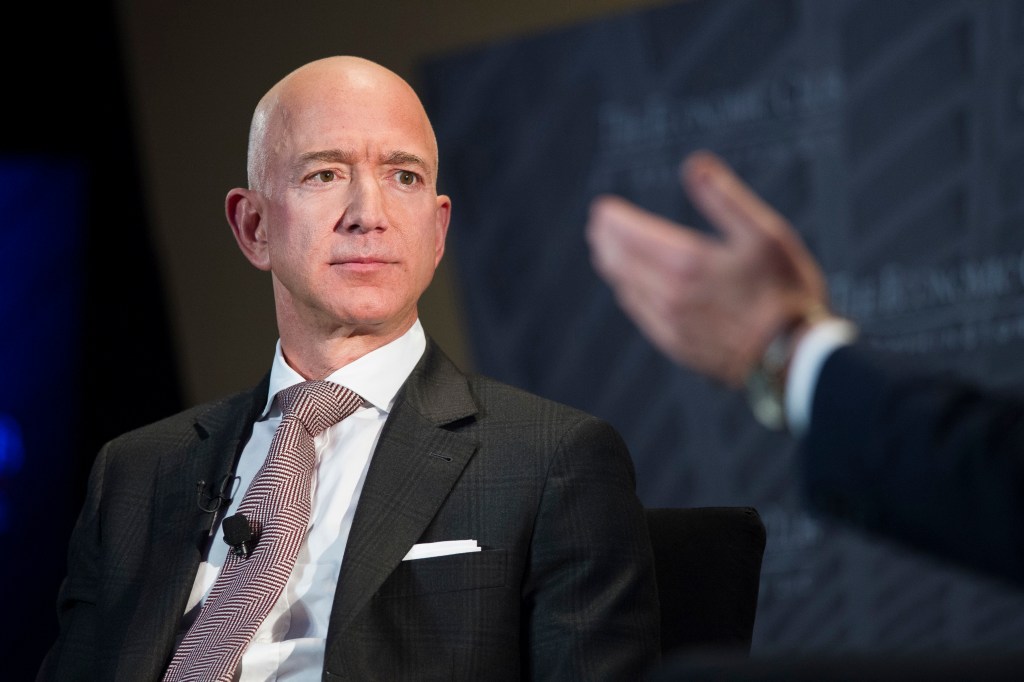 Jeff Bezos in coat and tie. 