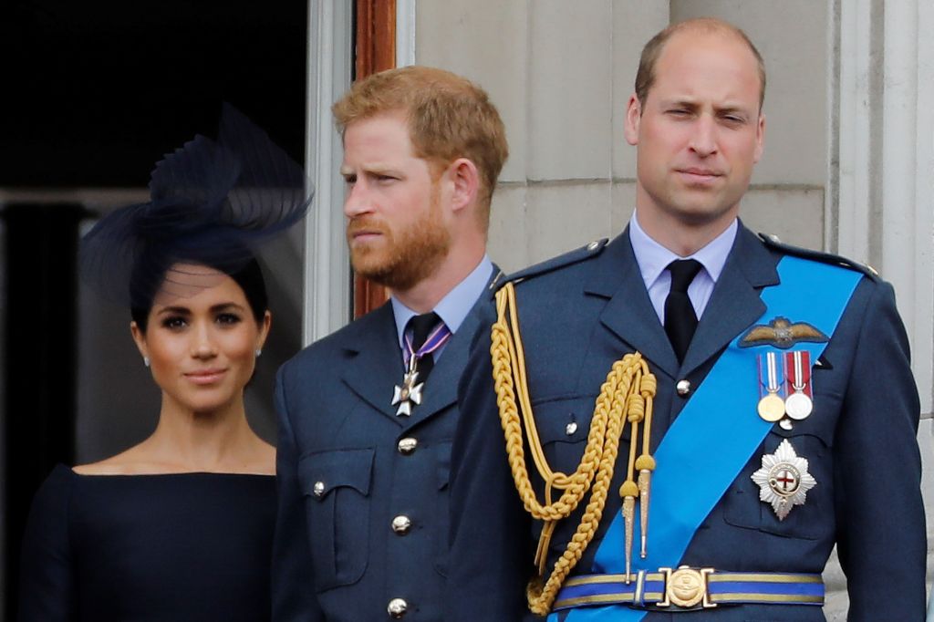 Prince Harry, Meghan Markle, and Prince William on the balcony of Buckingham Palace. 