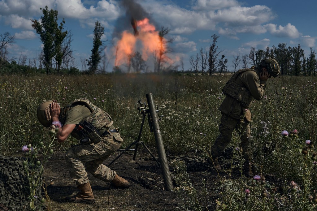 Ukrainian soldiers fire a mortar firing a mortar towards Russian positions near Bakhmut on August 12, 2023.