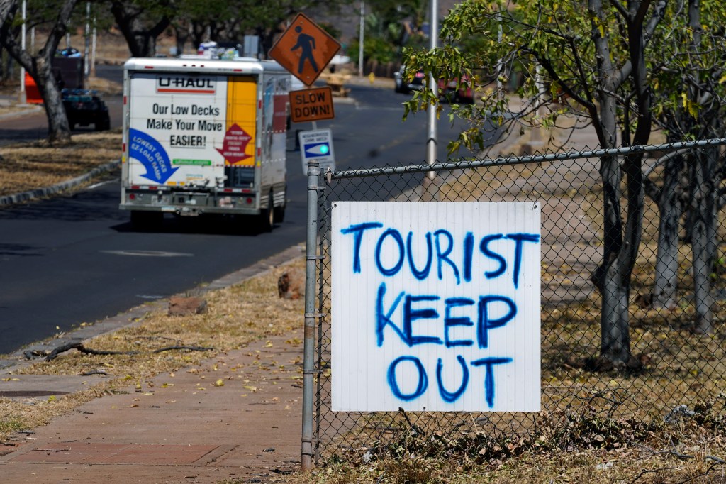 A "Tourist Keep Out" sign is displayed in a neighborhood/