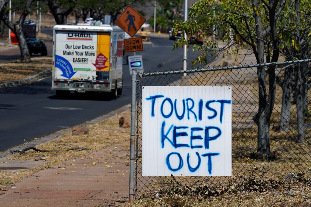 A sign displayed in Lahaina, Hawaii, on Sunday after a deadly wildfire that caused heavy damage days earlier.