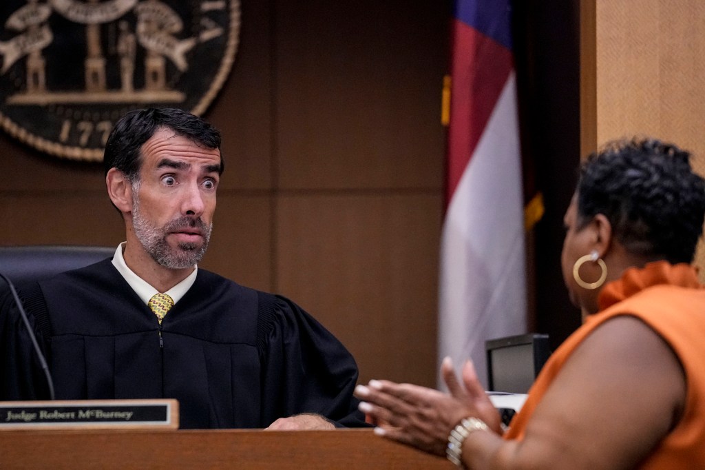 County Clerk Che Alexander, right speaks with Fulton County Superior Court Judge Robert McBurney.