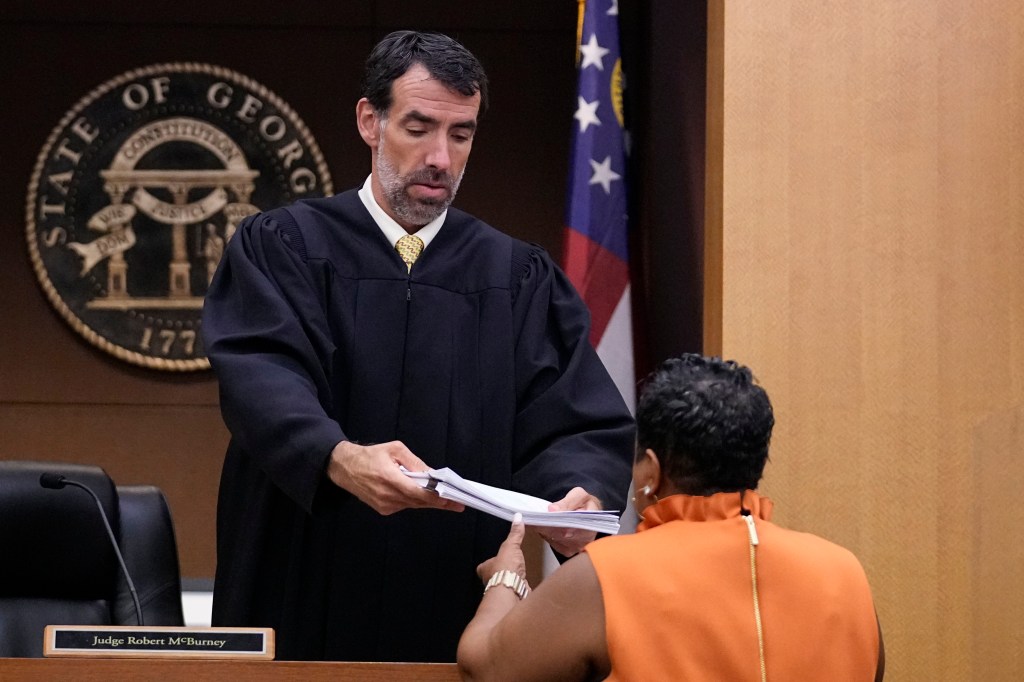 County Clerk Che Alexander, right, speaks with Fulton County Superior Court Judge Robert McBurney.