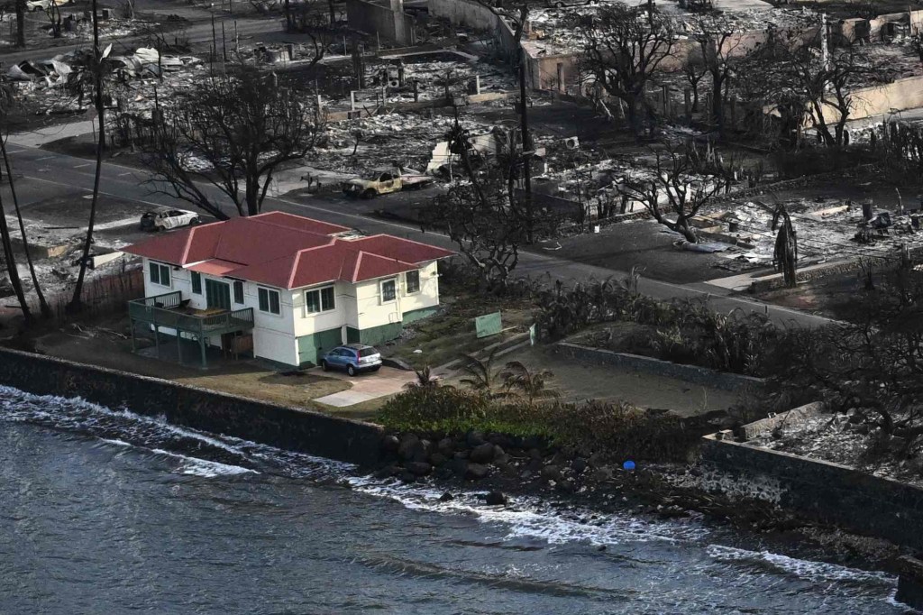 The house appeared to be shielded from the flames by the street, a parking lot, and the ocean. 