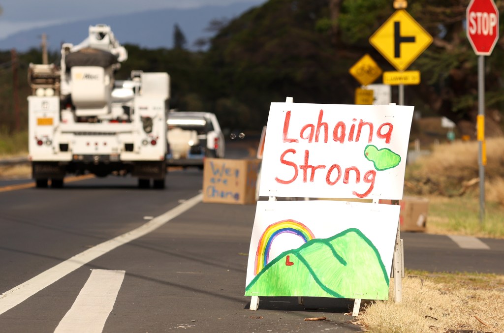 A sign in support of Lahaina stands in Olowalu near a site to donate supplies to. 