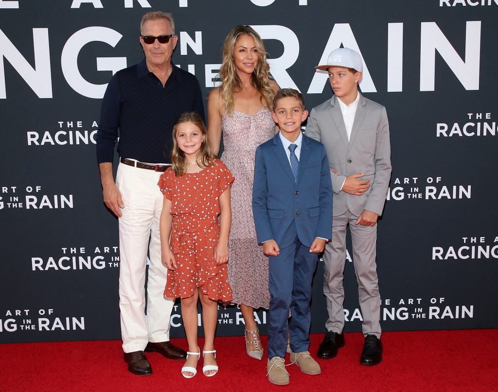 Kevin Costner and Christine Baumgartner attend the premiere of "The Art of Racing In The Rain" with their kids in 2019.