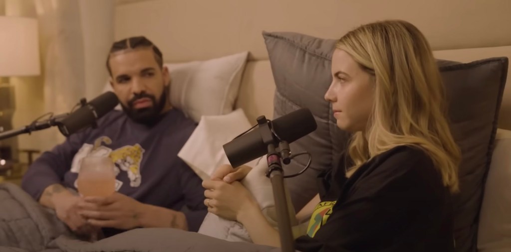 Drake in bed with Bobbi Althoff, with microphones in front of them. 