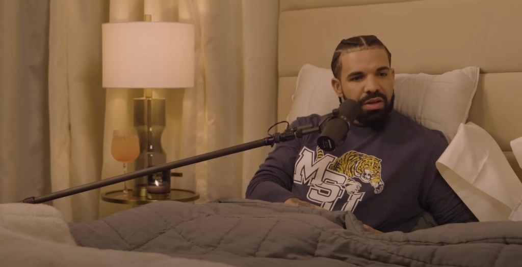 Drake in bed talking. 