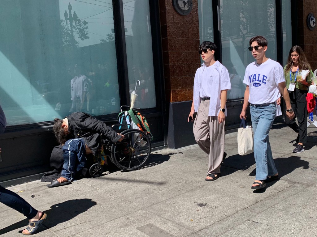 A homeless man sleeps by the former location of Old Navy on Market Street in San Francisco, California on Wednesday August 16, 2023. Many retailers are citing homeless problems and other challenges of operating in Downtown San Francisco and contemplating whether to remain open.