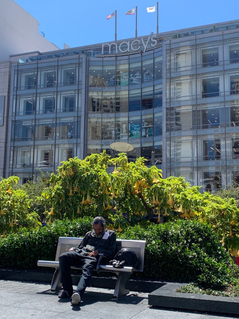 A homeless man sleeps near Macyâs Department Store in Union Square in San Francisco, California on Wednesday August 16, 2023. 