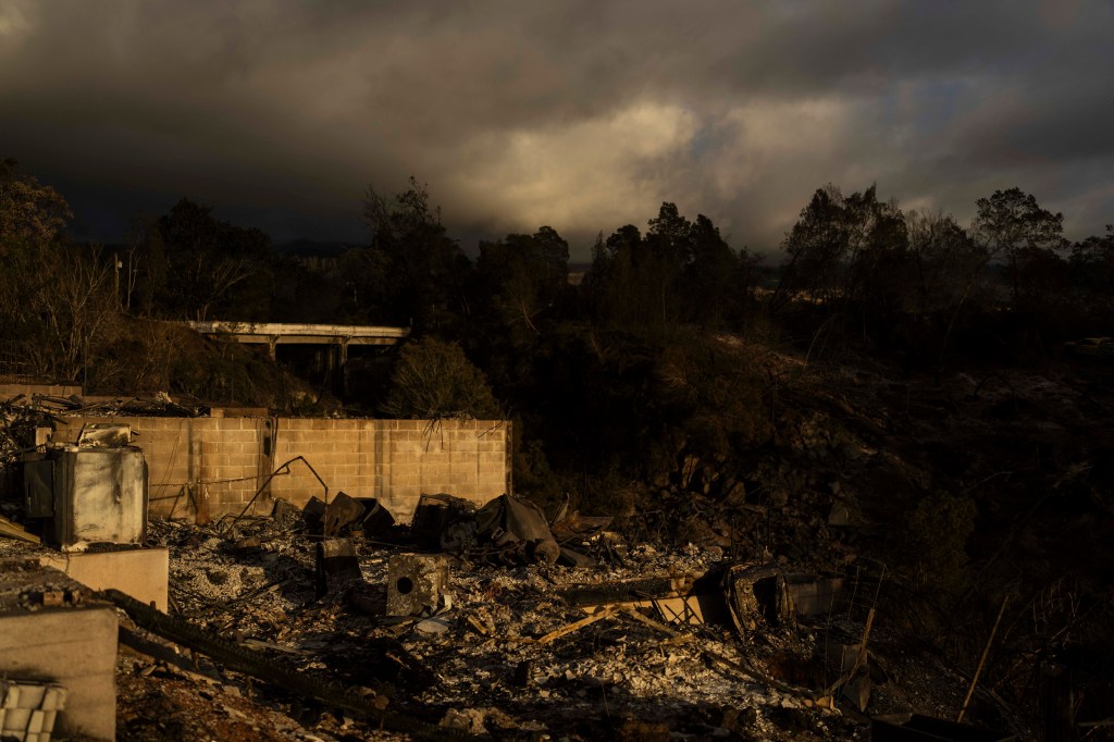 Clouds hang over a home destroyed in a wildfire in Kula, Hawaii.