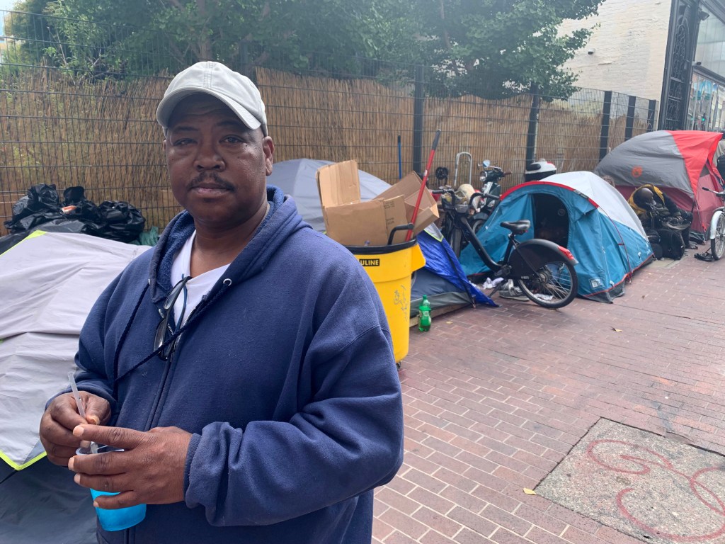JJ Smith, a long time resident of the Tenderloin District in San Francisco, California, by aa homeless area in the Tenderloin District on Thursday, August 17, 2023. 